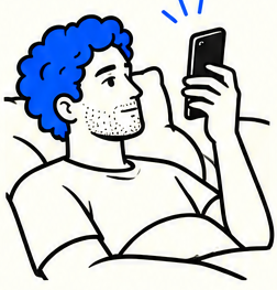 A man propped on a pillow looking at his phone